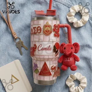 Pink tiled tumbler with Delta Sigma Theta Greek letters, elephant emblems, and a plush red elephant keychain.!