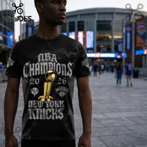Black graphic t-shirt featuring NBA Champions 2026 text, a gold Larry O'Brien trophy, and New York Knicks branding.!
