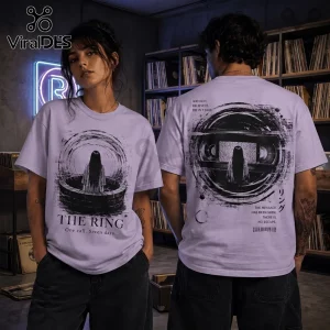 Lavender t-shirt featuring The Ring horror movie graphics. Front shows Samara in a well; back features a VHS tape graphic.!