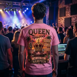 Pink t-shirt with Queen band graphics, royal crown, vintage microphone, and song titles worn by a man at a concert.!