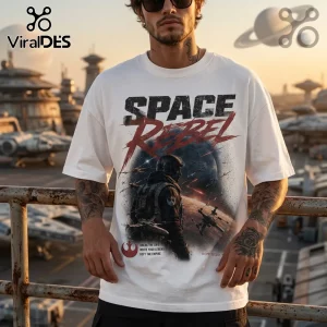 Man wearing white t-shirt featuring Space Rebel text, starfighter battle graphics, and a Rebel Alliance logo.!