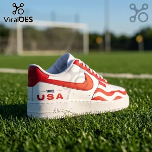 Custom white leather sneaker with red wavy stripes and USA text on a green grass soccer field background.!