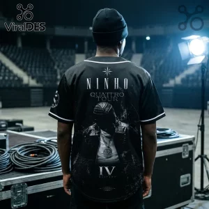 Black baseball jersey with Ninho Quattro Tour graphic, portrait print, text IV, and white trim worn in a concert arena.!