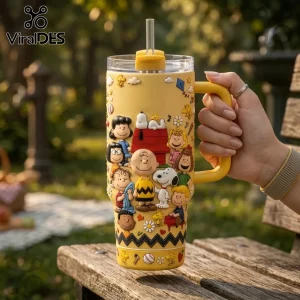 Yellow insulated tumbler featuring raised Peanuts character graphics including Snoopy, Charlie Brown, and his doghouse.!