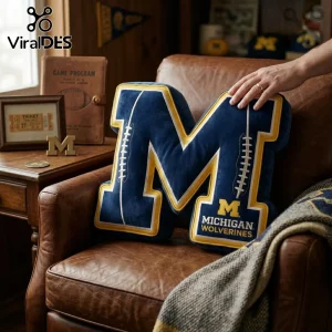 Michigan Wolverines M-shaped navy blue and yellow plush throw pillow featuring embroidered football lace designs.!