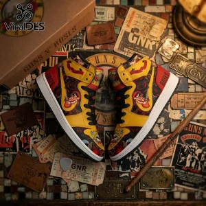 Guns N' Roses high-top sneakers with yellow, red, and black floral print on a surface with vintage concert tickets and gear.!