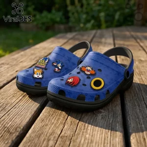 Blue foam clogs featuring Sonic the Hedgehog charms including Tails, Knuckles, Dr. Eggman, and a golden ring on wood.!