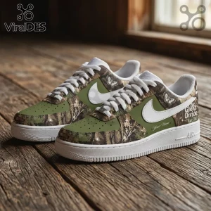 Custom olive green and camo sneakers with white swoosh, butterfly graphics, and text The Great Divide on wood floor.!