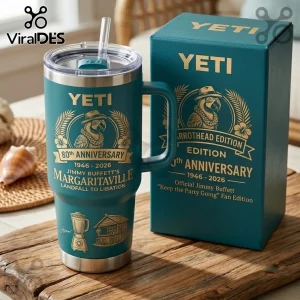 Yeti Jimmy Buffett 80th Anniversary Teal 40oz Tumbler with parrot graphic, straw, and branded box on wooden surface.