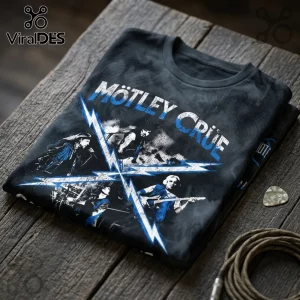 Motley Crue 2026 The Return of Carnival of Sins shirt in black with blue lightning graphics on a wooden surface.