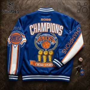 Blue New York Knicks 2026 Champions varsity jacket with orange and white embroidery, trophy graphics, and leather sleeve.!