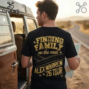 Man wearing a black t-shirt with gold distressed text reading Finding Family on the road Alex Warren 26 Tour by a van.!