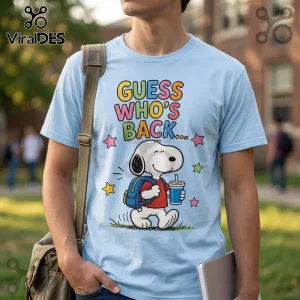 Light blue t-shirt featuring Snoopy carrying a backpack and drink with multicolored text reading GUESS WHO'S BACK.!