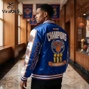 Man wearing blue and white satin New York Knicks 2026 Champions varsity jacket with trophy embroidery in a hallway.!
