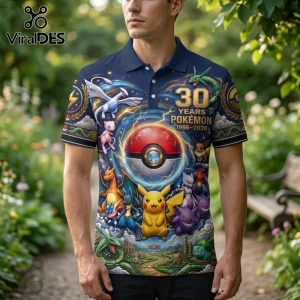 Navy blue polo shirt with Pokémon 30th anniversary graphic featuring Pikachu, Mewtwo, and a central Poké Ball design.!