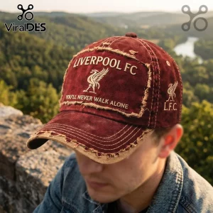 Distressed maroon Liverpool FC baseball cap with embroidered team logo and You'll Never Walk Alone text against nature.!