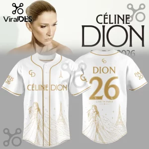 White baseball jersey with gold Celine Dion branding, Eiffel Tower graphics, and singer illustrations on front and back.!