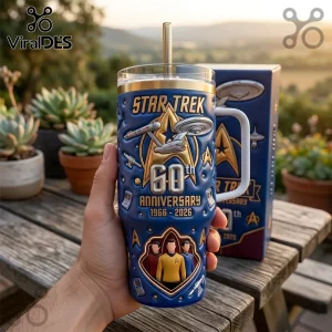 Star Trek 60th anniversary blue 3D embossed tumbler with USS Enterprise, gold logo, and crew silhouettes on a wood table.!
