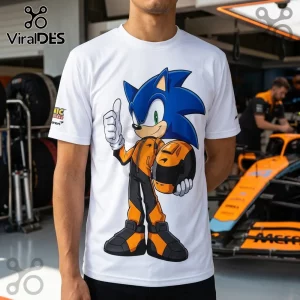 White crew neck t-shirt featuring Sonic the Hedgehog wearing a McLaren racing suit and holding a matching orange helmet.!