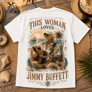 White graphic t-shirt featuring a man playing guitar on a beach with the text This Woman Loves Jimmy Buffett.!