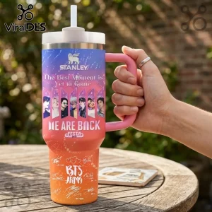BTS 2025 Festa Stainless Steel Handle Tumbler featuring member portraits, pink handle, and white straw on wooden table.