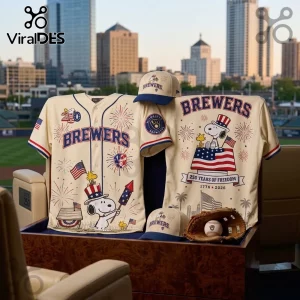 Cream-colored Milwaukee Brewers baseball jerseys and caps featuring Snoopy, Woodstock, fireworks, and USA flags.!