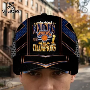 New York Knicks 2020 NBA Champions baseball cap with black, blue, and orange graphics on a blurred city street background.!