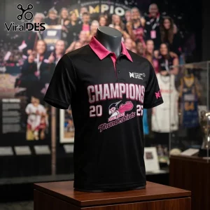 Black and pink Adelaide Thunderbirds Suncorp Super Netball Champions 2023 polo shirt on a mannequin display stand.!