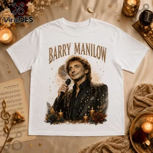 White cotton t-shirt featuring a vintage-style graphic of Barry Manilow holding a microphone surrounded by gold stars.!
