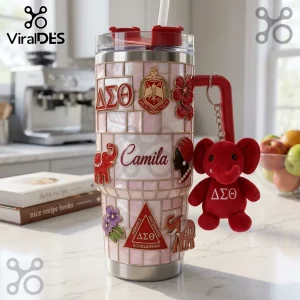 Pink tiled stainless steel tumbler featuring Delta Sigma Theta Greek letters, a plush red elephant charm, and name Camila.!