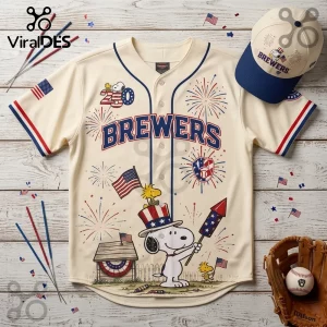 Cream Milwaukee Brewers baseball jersey with Snoopy, Woodstock, fireworks, and American flag graphics, plus matching hat.!