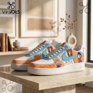 Hocus Pocus Bluey Witch Character Custom Air Force 1 Sneakers featuring orange, blue, and white graphics on a desk.