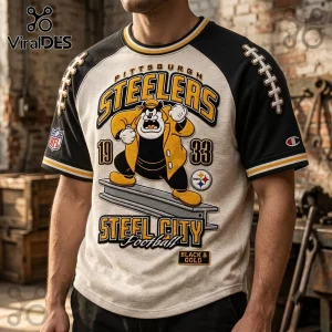 Pittsburgh Steelers NFL Mascot Shirt featuring a cartoon character on a grey torso with black raglan sleeves and team logos.