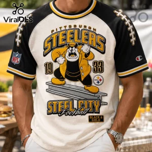 Pittsburgh Steelers NFL Mascot Shirt featuring a cartoon character, team text, and football graphics on a black and white tee.