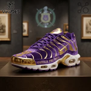 Omega Psi Phi Collector Edition Air Max Plus Shoes in purple velvet with gold accents on a gallery pedestal.