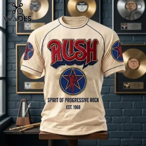 Rush Progressive Rock Band beige t-shirt with Starman logo, red lettering, and navy contrast stitching on a wooden stand.