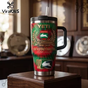 South Sydney Rabbitohs 118th Anniversary 40oz Tumbler with red and green tie-dye pattern on a wooden pedestal.
