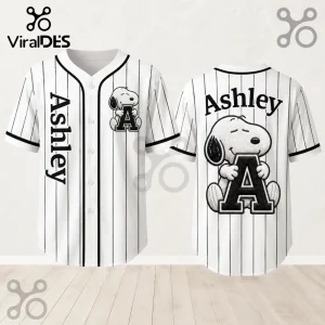 Personalized Snoopy Comic Strip Baseball Jersey featuring black pinstripes, letter A with Snoopy, and custom name Ashley.