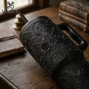 Matte Black Halloween Bat Floral 40oz Tumbler with embossed gothic rose, bat, and candle patterns on a wooden table.