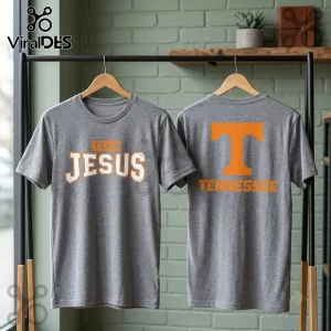 Tennessee Volunteers Team Jesus Heather Gray Shirt showing front text and back orange logo on a rack against green wall.