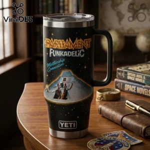 Parliament Funkadelic 58 Years Stanley Tumbler 40oz features a black space design with a mothership graphic on a desk.