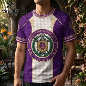 Omega Psi Phi Fraternity Purple Crest T-Shirt featuring a central shield logo, gold Greek patterns, and white panels.