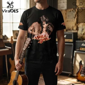 A Star Is Born 1976 50th Anniversary Black Shirt featuring a graphic of the film leads on a male model holding a guitar.