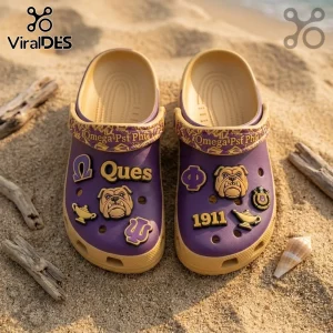 Omega Psi Phi Mascot Slip On Clogs With Charms in purple and gold on sand with bulldog, 1911, and greek letter accents.