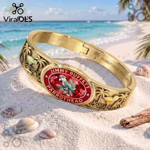 Jimmy Buffett Margaritaville gold tone engraved bracelet with a red center stone, palm tree motifs, and beach background.