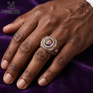 Omega Psi Phi Que Dogs gold ring featuring a central purple stone and fraternity insignias worn on a male hand.