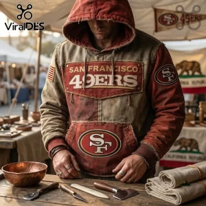 San Francisco 49ers Weathered Canvas Pullover Hoodie featuring red and tan panels, SF logo, and raw-edge hood details.