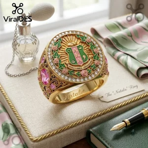 Custom Alpha Kappa Alpha Sorority Ring in gold featuring a green and pink crest, ivy leaves, and clear crystal accents.