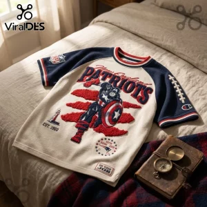 New England Patriots x Captain America Vintage Embroidered Shirt featuring blue and red textured graphics on a beige tee.