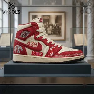 Delta Sigma Theta 1913 Air Jordan 1 High Top Sneakers in cream and crimson with elephant embroidery in a museum display case.